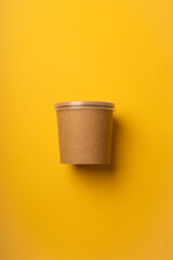 No plastic glasses for delivery on yellow background