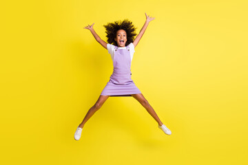 Fototapeta na wymiar Full length body size view of pretty amazed cheerful crazy wavy-haired girl jumping having fun isolated over vivid yellow color background