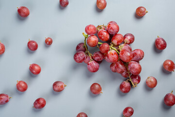 Bunches of fresh ripe red grapes on blue background.