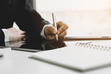 Fototapeta premium Businessman using laptop computer and digital tablet analyzing sales data and economic growth, financial graph chart. Business strategy analysis