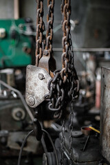 Old rusty chains inside an industrial warehouse