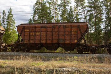 Fototapeta premium Hopper on the railroad. The hopper rail car is designed for the transportation of bulk bulk cargo.