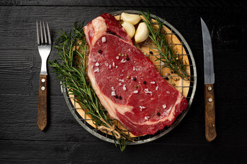 fresh raw beef steak on the dark background.