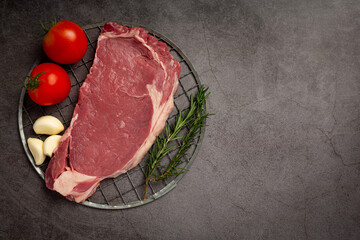 fresh raw beef steak on the dark background.