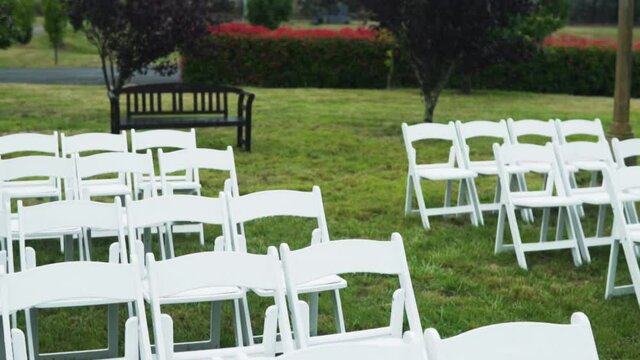 White Chairs arranged on the garden for the wedding. close up