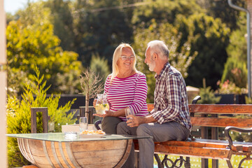 Elderly couple having an outdoor brunch