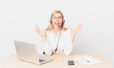 blonde pretty woman young blonde woman feeling happy and astonished at something unbelievable and...