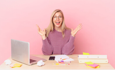 blonde pretty woman young blonde woman feeling happy and astonished at something unbelievable and...