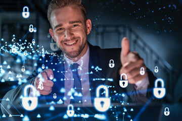 Portrait of handsome businessman thinking how to protect clients confidential information and cyber security. IT hologram padlock icons over office background.