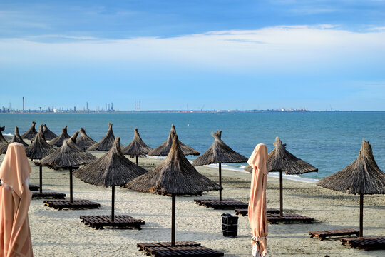 empty beach chairs and umbrellas after opening time (in the evening) - Navodari, Constanta, Dobrudja, Romania, Europe, Black Sea