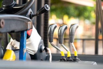 Close-up at gearing lever of forklift vehicle. An industrial, transportation and logistic equipment...