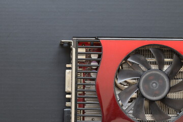 An old video card with an air cooling system for a computer on a black background. 