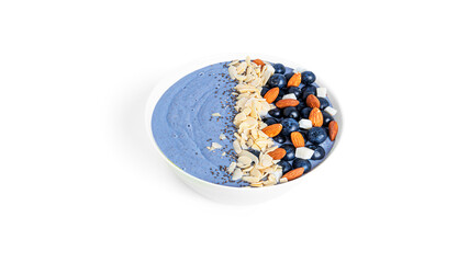 Blueberries dessert with fruits, almond and chia seeds isolated on a white background. Blue smoothie bowl with berries.