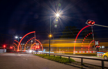 train passes Railroad crossing at night