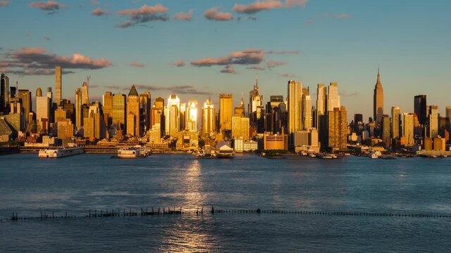 New York City sunset to dusk timelapse on Manhattan Midtown West and its skyscrapers along the Hudson River. USA