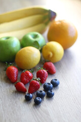 Various colorful fruit on wooden background. Selective focus.