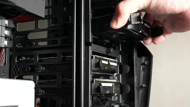 Closeup view 4k stock video footage of male hand removes and inserts old dusty hdd (hard drive disks) into computer case