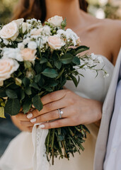 Closeup of engagement diamond ring on bride hand.