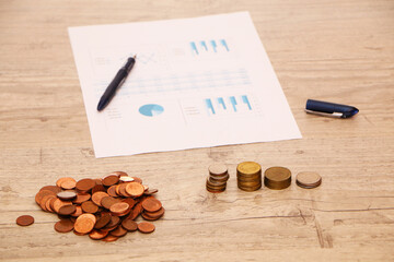 Money and a financial income chart are on the desk in the office.