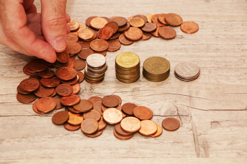 A man's hand is counting money for a report in the office.