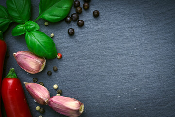 Chilli pepper, dry pepper,  garlic on slate black stone plate.