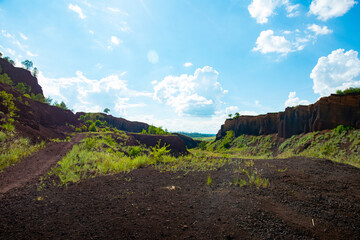 limestone cliffs from the old volcano and green vegetation in the middle of the plain - 434335601