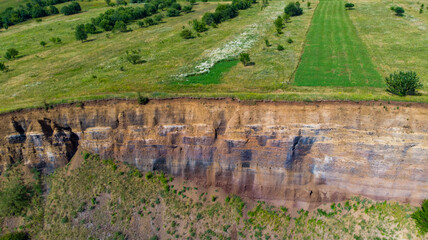 limestone cliffs from the old volcano and green vegetation in the middle of the plain