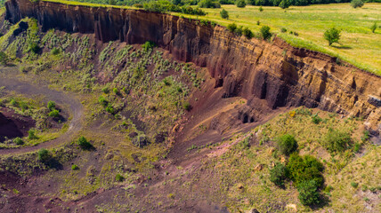 limestone cliffs from the old volcano and green vegetation in the middle of the plain - 434335885