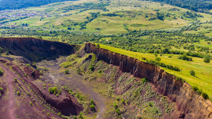 limestone cliffs from the old volcano and green vegetation in the middle of the plain - 434336065