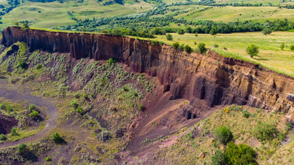 limestone cliffs from the old volcano and green vegetation in the middle of the plain - 434336249