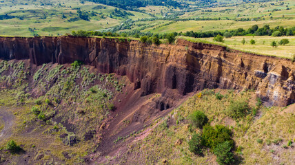 limestone cliffs from the old volcano and green vegetation in the middle of the plain - 434336294