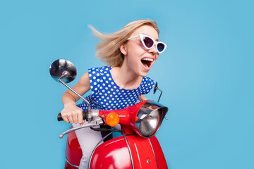 Fototapeta na wymiar Profile side photo of young excited girl happy positive smile ride scooter fast speed isolated over blue color background