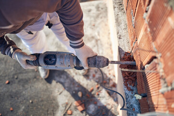Real construction worker working on a house renovation - authentic person on the job.