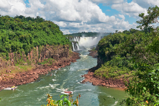 Iguazu waterfalls in Argentina, view from Devil's Mouth. Panoramic view of many majestic powerful water cascades with hanging mist. Panoramic image of Iguazu valley from above.