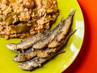 Fried small sardines with green beans fresh rice. Traditional Portuguese Food.