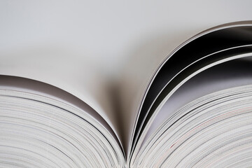 Open book with white blank pages on white background with narrow depth of field