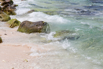 The clear water and the rocks on the shore