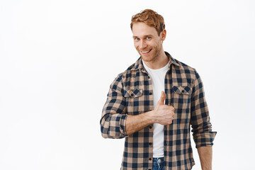 Well done, very good. Handsome smiling man with red hair, showing thumbs up to praise and...