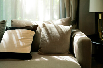 closeup Natural earthtone color fabric textile pillow on armchair and sofa in living room interior design