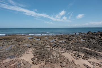 Fototapeta na wymiar rock on the beach and blue sky