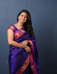 Fotobehang Smiling Attractive Indian Woman in saree Showing Copyspace or presenting © Ojas