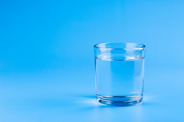 Fresh water in glass on aqua blue background. Part of set.