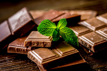 black and milk chocolate bars dark wooden table background