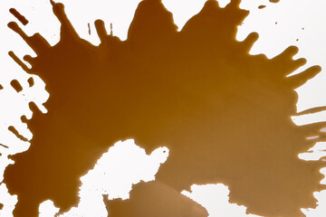 Close-up of Fresh spilled black coffee from mug on white background. Empty place for text. Selective focus