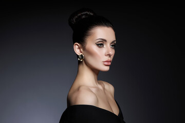 Classic beauty portrait of woman with perfect evening makeup on dark background. Perfect skin...