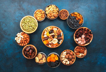 Nuts and dried fruits. Dried apricots, figs, raisins, pecans, walnuts, hazelnuts, almonds and other. Blue background, top view