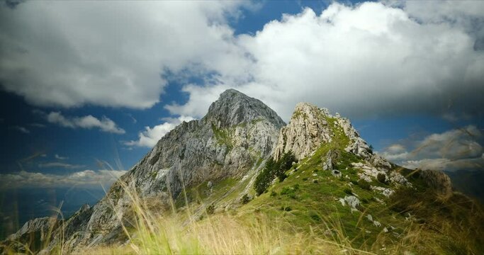 Clouds on top of a mountain in the Apuan Alps in Tuscany.Timelapse of the passage of clouds pushed by the wind in the blue sky on Pizzo d'Uccello. Apuan Alps, Tuscany, Italy. 
