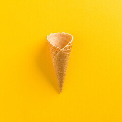 Ice Cream Empty Waffle Cone on solid yellow background in square format