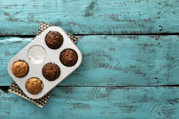 gluten-free almond flour muffins, keto food, on painted wooden boards, bright turquoise color, texture, background, top view, empty space for text
