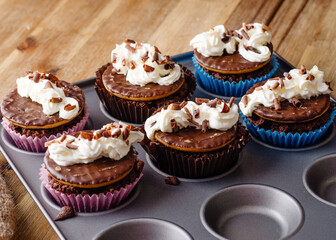 homemade chocolate cupcakes in cupcake mold on the table in the kitchen